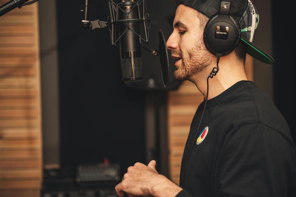 Hiring a freelancer for faceless youtube voice-overs Brett Sayler Voice overing in a booth